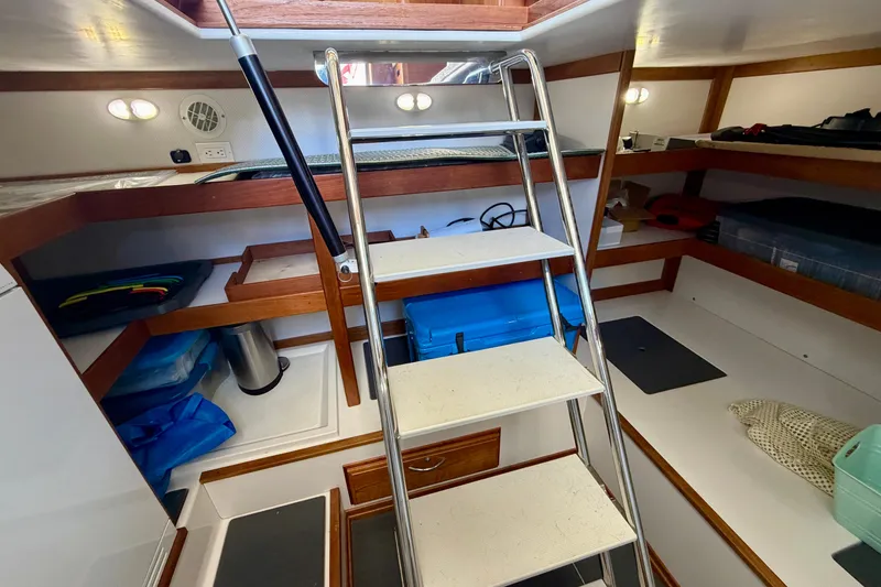 Slide: The Image of Interior of 2016 Sabre 48 Salon Express yacht with ladder and storage shelves. - 50