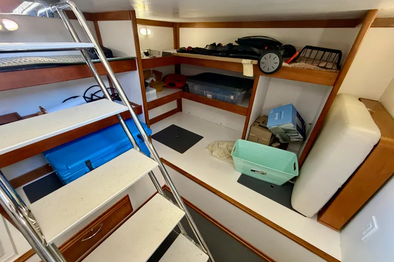 Slide: The Image of Interior storage area of 2016 Sabre 48 Salon Express with shelves and stairs. - 51