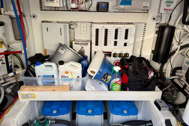 Slide: The Image of Engine room of 2016 Sabre 48 Salon Express with maintenance supplies and control panels. - 57