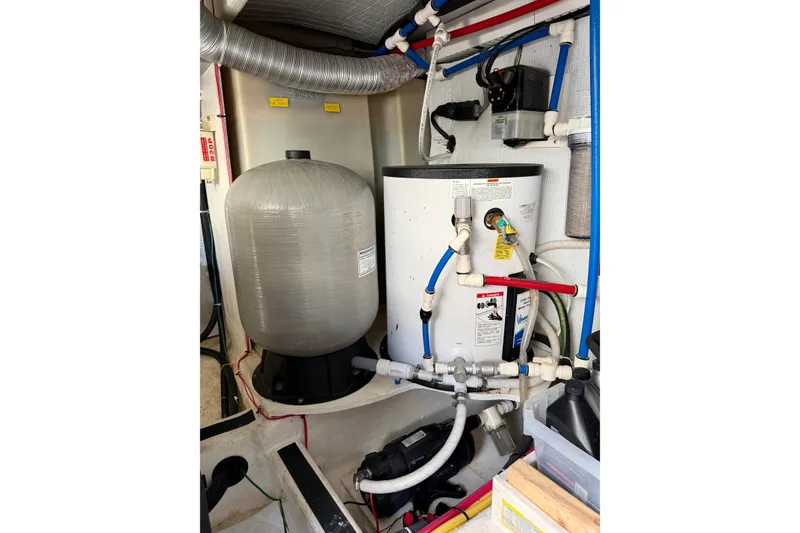 Slide: The Image of Engine room of 2016 Sabre 48 Salon Express with water heater and plumbing system. - 59
