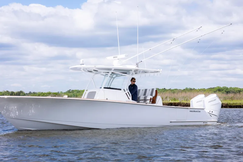 Slide: The Image of 2025 Valhalla Boatworks V-33 cruising on water under a cloudy sky. - 1