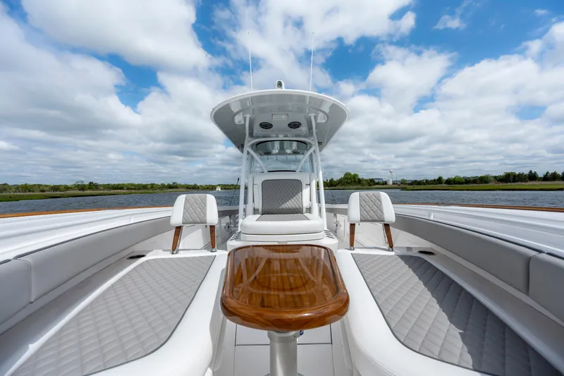 Slide: The Image of 2025 Valhalla Boatworks V-33 luxury boat interior with elegant seating and wooden table. - 10