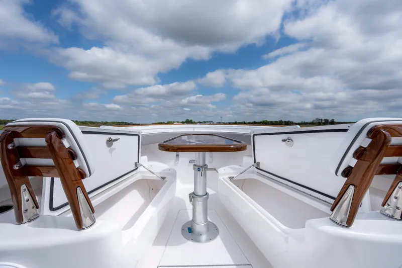 Slide: The Image of 2025 Valhalla Boatworks V-33 interior with wooden accents and open storage compartments. - 15