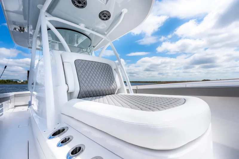 Slide: The Image of 2025 Valhalla Boatworks V-33 with luxurious seating and sleek design under a blue sky. - 19