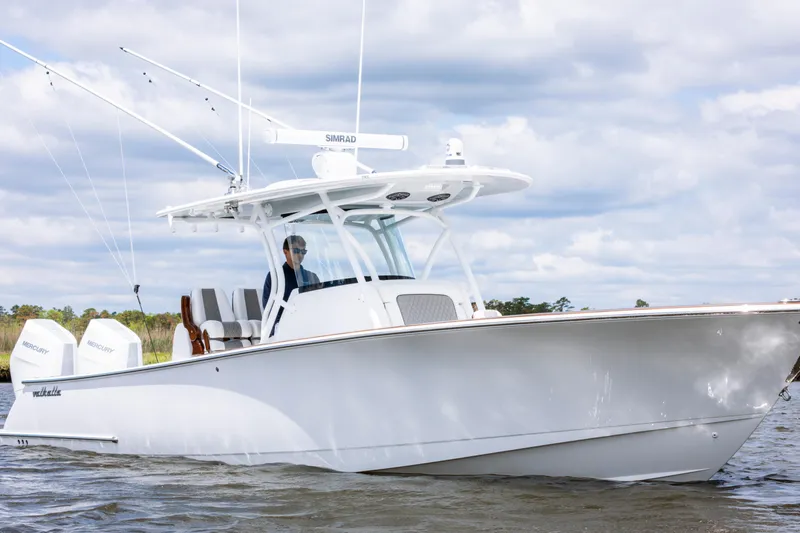 Slide: The Image of 2025 Valhalla Boatworks V-33 cruising on water under cloudy sky. - 2