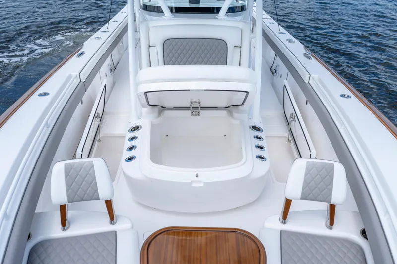 Slide: The Image of 2025 Valhalla Boatworks V-33 interior with seating and storage, on water. - 20