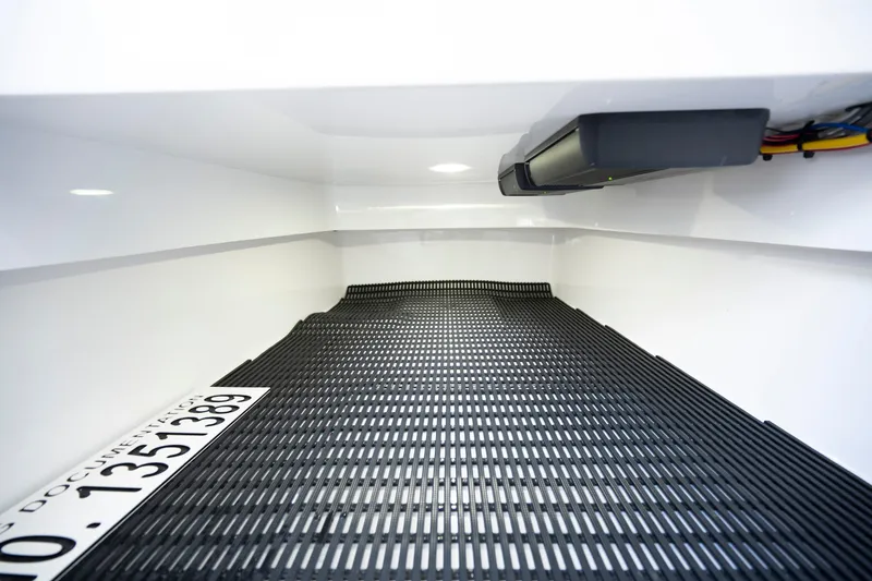 Slide: The Image of Interior storage compartment of 2025 Valhalla Boatworks V-33 with black matting. - 27