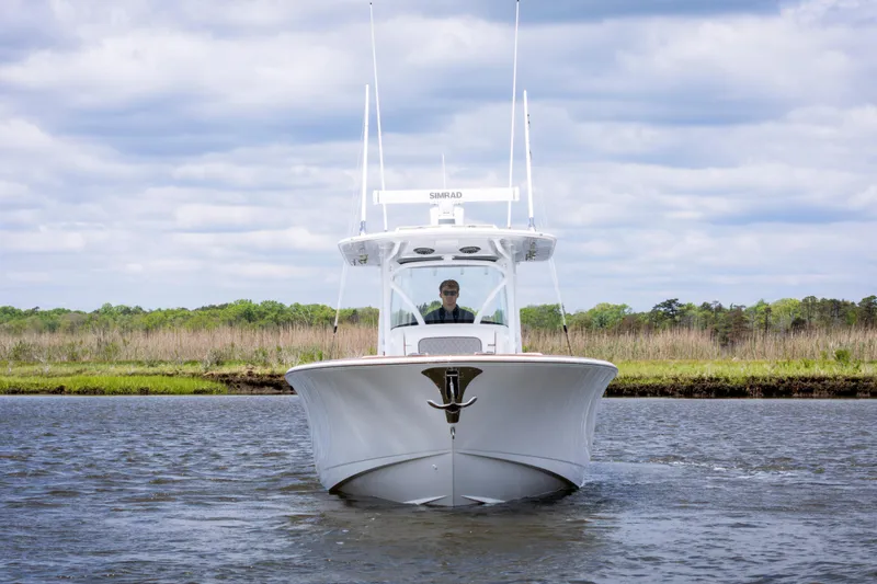 Slide: The Image of 2025 Valhalla Boatworks V-33 cruising on a serene river under a cloudy sky. - 3