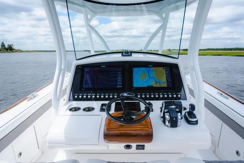 Slide: The Image of 2025 Valhalla Boatworks V-33 helm with dual navigation screens on open water. - 31