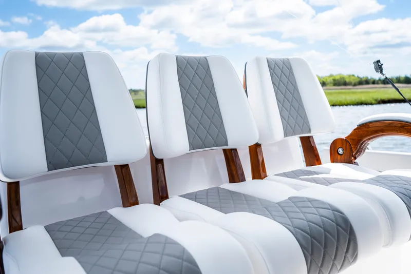 Slide: The Image of 2025 Valhalla Boatworks V-33 seats with quilted design, set against a scenic water backdrop. - 34