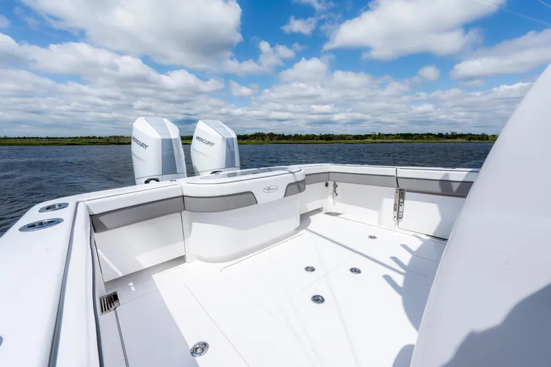 Slide: The Image of 2025 Valhalla Boatworks V-33 deck with twin Mercury engines on a sunny day. - 38