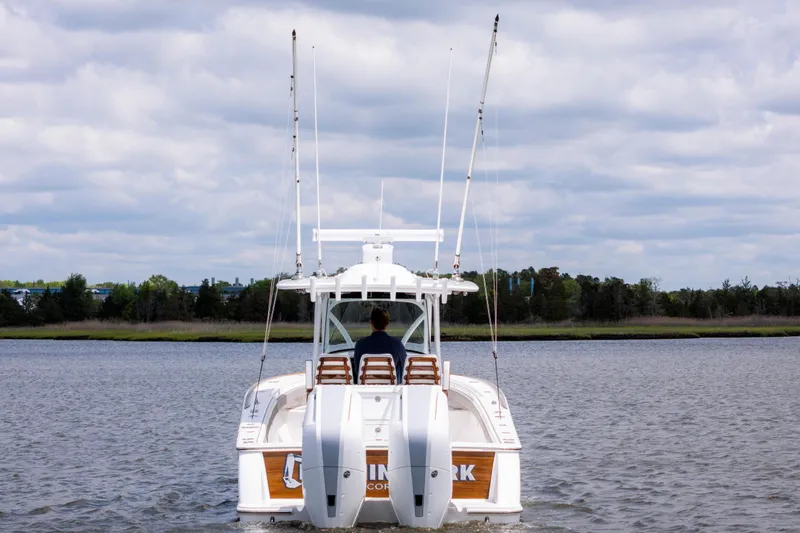 Slide: The Image of 2025 Valhalla Boatworks V-33 cruising on a calm lake under cloudy skies. - 4