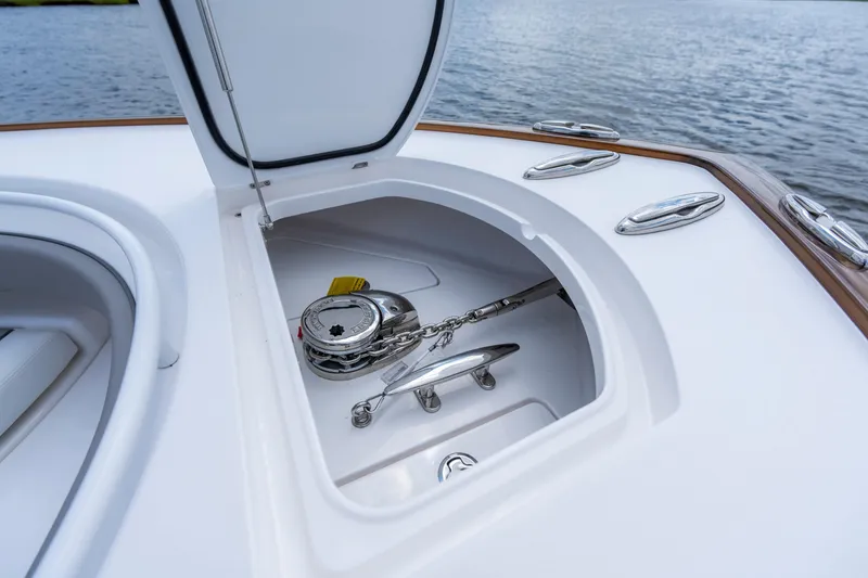 Slide: The Image of Open anchor locker on 2025 Valhalla Boatworks V-33, showcasing chain and cleat. - 8