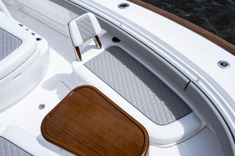 Slide: The Image of Luxurious seating area on 2025 Valhalla Boatworks V-33, featuring elegant wood and quilted upholstery. - 9