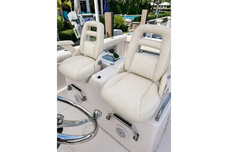 Slide: The Image of Luxurious seating on 2014 Grady-White Canyon 306 boat, featuring plush white upholstery. - 18