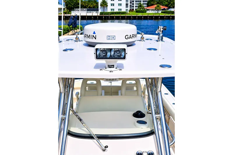 Slide: The Image of 2014 Grady-White Canyon 306 boat with Garmin radar, docked near waterfront buildings. - 19