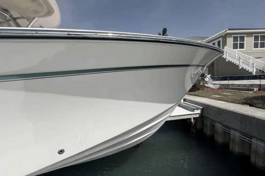 Slide: The Image of 2014 Grady-White Canyon 306 boat docked near waterfront property. - 2