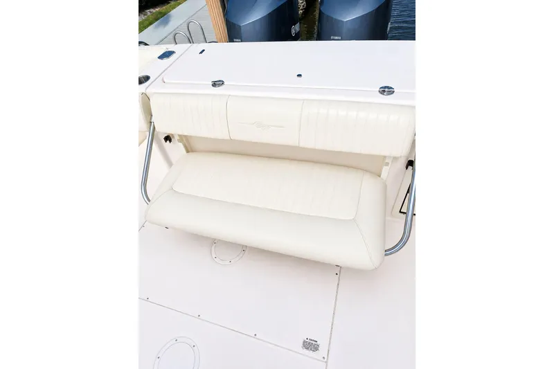 Slide: The Image of 2014 Grady-White Canyon 306 boat seat with white upholstery and stainless steel supports. - 22