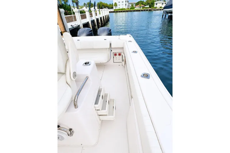 Slide: The Image of 2014 Grady-White Canyon 306 boat interior, featuring sleek seating and dockside view. - 23
