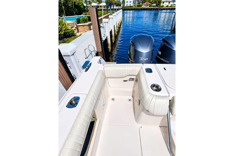 Slide: The Image of 2014 Grady-White Canyon 306 boat with twin Yamaha 300 engines docked by water. - 24