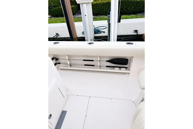 Slide: The Image of 2014 Grady-White Canyon 306 boat interior with rod holders and storage. - 26