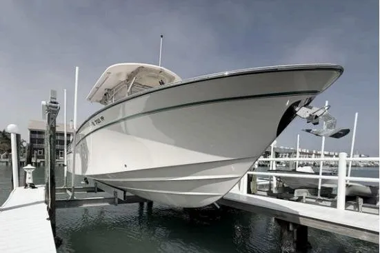 Slide: The Image of 2014 Grady-White Canyon 306 boat docked at marina, side view. - 3