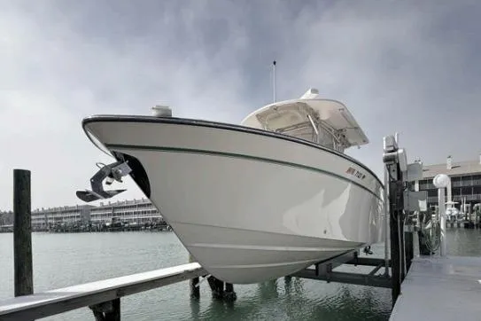 Slide: The Image of 2014 Grady-White Canyon 306 boat docked at marina, side view. - 4