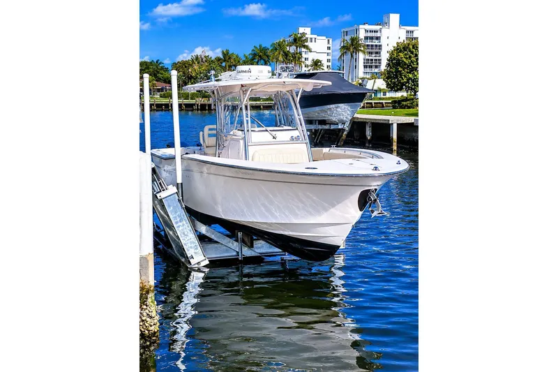 Slide: The Image of 2014 Grady-White Canyon 306 boat docked on a sunny waterfront. - 6