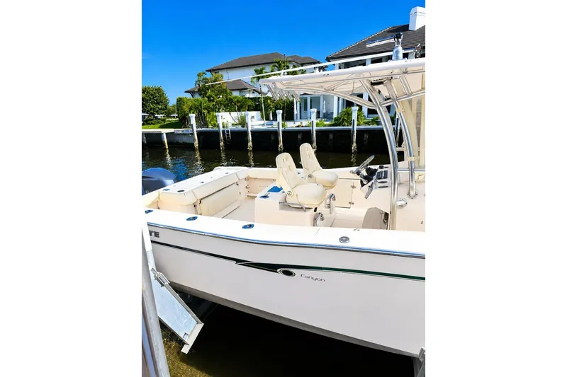 Slide: The Image of 2014 Grady-White Canyon 306 boat docked near waterfront homes. - 8