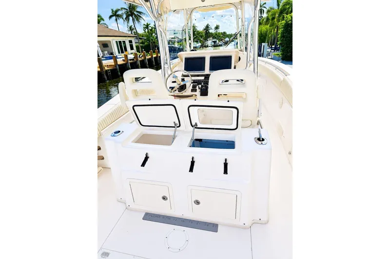 Slide: The Image of 2014 Grady-White Canyon 306 boat interior with helm and storage compartments. - 9