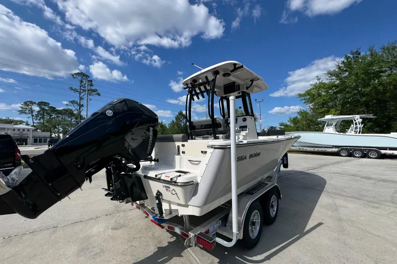 Slide: The Image of 2027 Sea Born LX22 Center Console boat on trailer under blue sky. - 11
