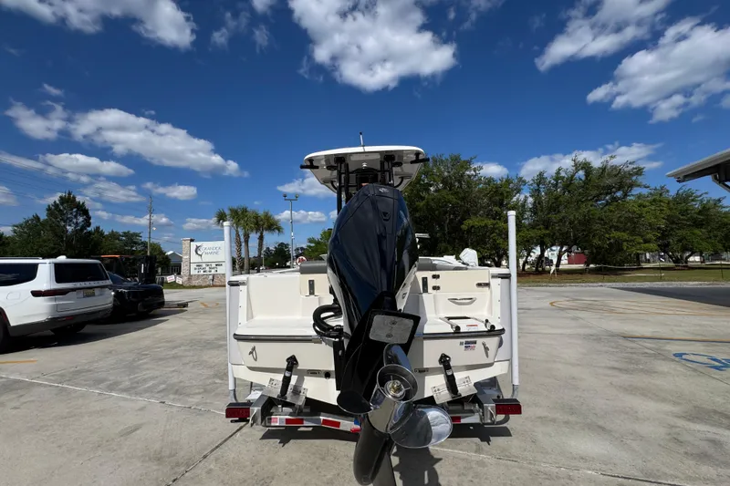 Slide: The Image of 2027 Sea Born LX22 Center Console boat on trailer under blue sky. - 13