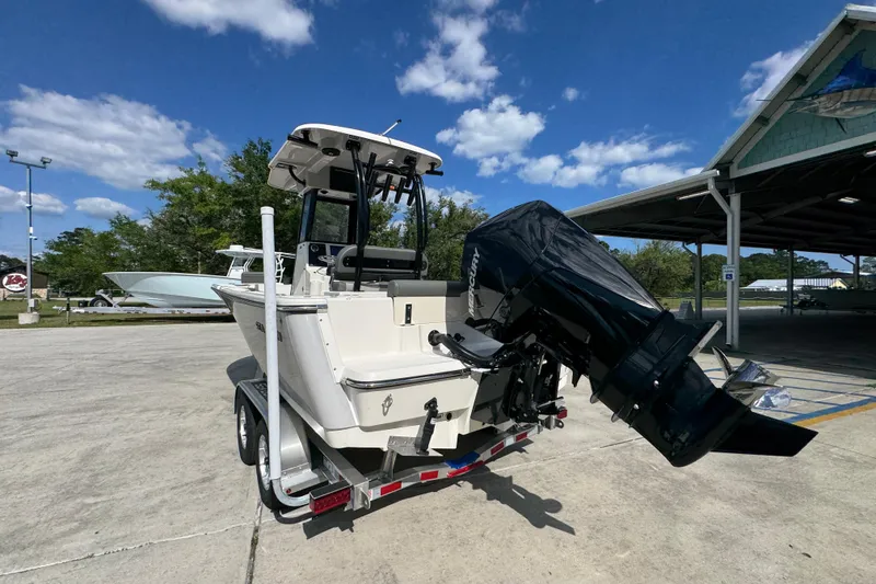 Slide: The Image of 2027 Sea Born LX22 Center Console boat on trailer, featuring powerful outboard motor. - 14