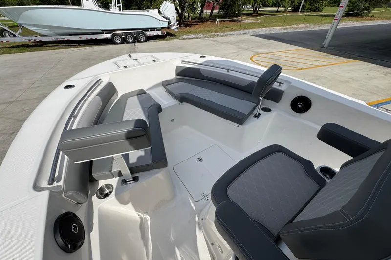 Slide: The Image of 2027 Sea Born LX22 Center Console boat interior with gray seating and cup holders. - 18