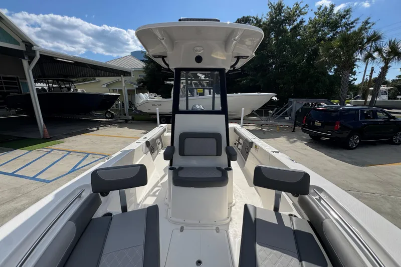 Slide: The Image of 2027 Sea Born LX22 Center Console boat at a marina, showcasing seating and console design. - 21
