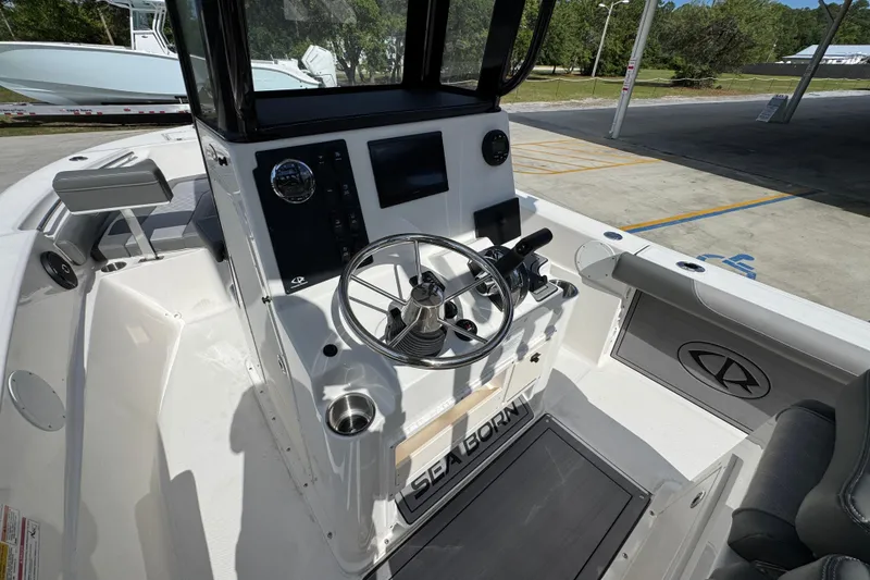 Slide: The Image of 2027 Sea Born LX22 Center Console boat interior with steering wheel and control panel. - 27