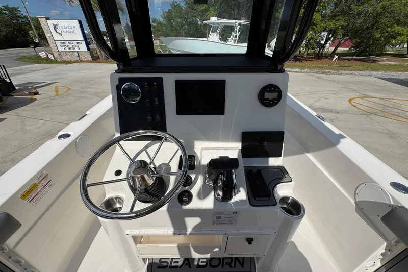 Slide: The Image of 2027 Sea Born LX22 Center Console boat dashboard with steering wheel and controls. - 28