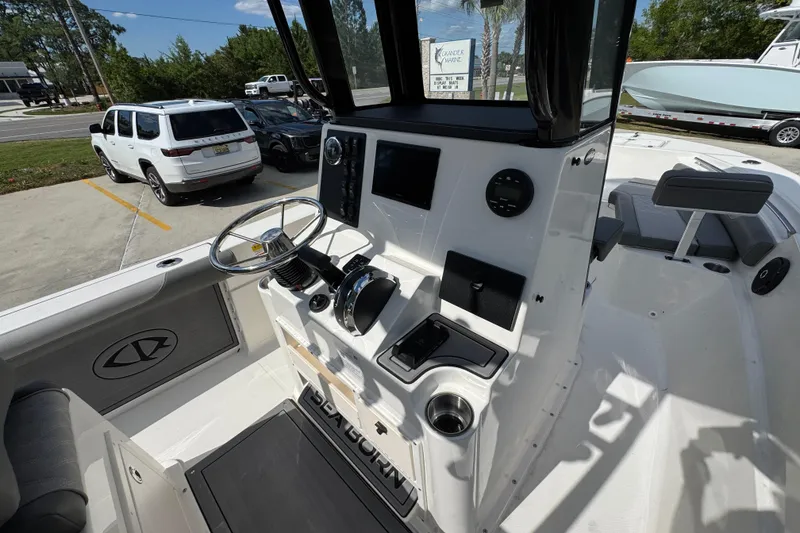 Slide: The Image of 2027 Sea Born LX22 Center Console boat interior with steering wheel and control panel. - 29