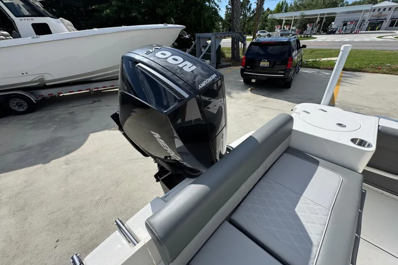 Slide: The Image of 2027 Sea Born LX22 Center Console boat with Mercury outboard engine at a marina. - 34