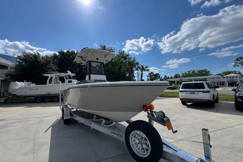 Slide: The Image of 2027 Sea Born LX22 Center Console boat on trailer under sunny sky. - 6