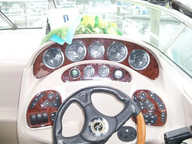 Slide: The Image of Dashboard of a 2002 Sea Ray Sundancer 280 boat with wood trim. - 4