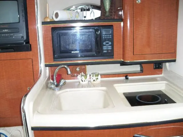Slide: The Image of Kitchen area in a 2002 Sea Ray Sundancer 280 yacht. - 8