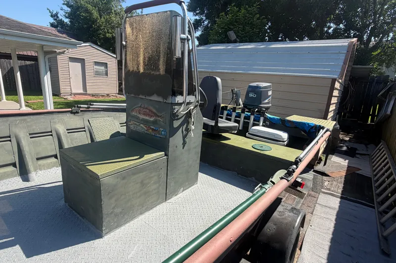 Slide: The Image of 2005 Southfork 1860 boat with outboard motor in a backyard setting. - 11