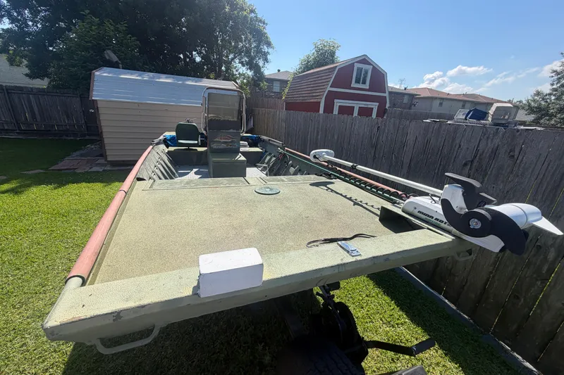 Slide: The Image of 2005 Southfork 1860 boat in backyard, featuring trolling motor and spacious deck. - 3