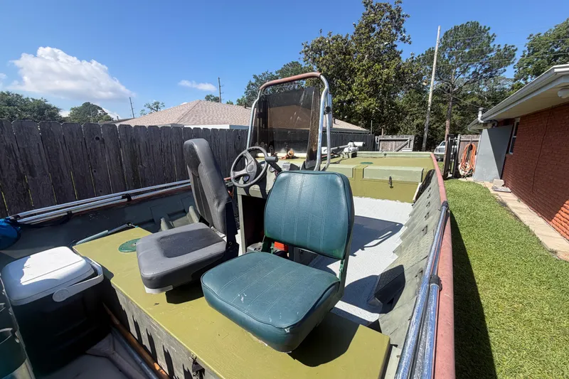 Slide: The Image of 2005 Southfork 1860 boat with dual seats and steering wheel, parked outdoors. - 6