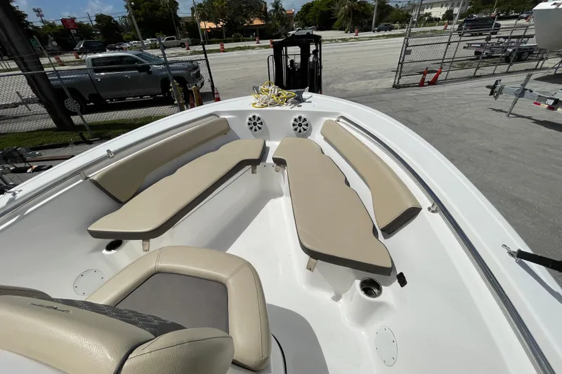 Slide: The Image of 2022 Tidewater 198 CC Adventure boat interior with beige seating and speakers. - 12
