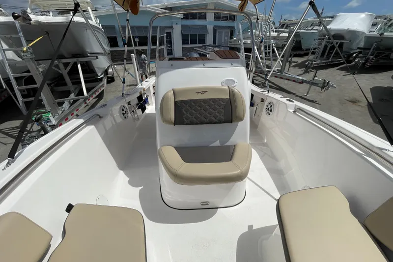 Slide: The Image of 2022 Tidewater 198 CC Adventure boat interior with beige seating and modern design. - 13