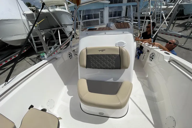 Slide: The Image of 2022 Tidewater 198 CC Adventure boat interior with seating and console view. - 14