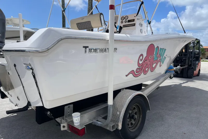 Slide: The Image of 2022 Tidewater 198 CC Adventure boat on trailer with octopus graphic, parked outdoors. - 3