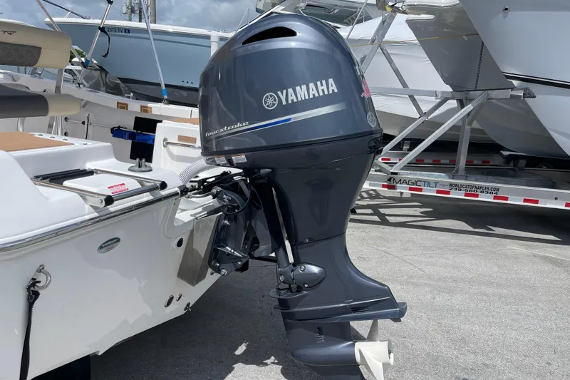 Slide: The Image of 2022 Tidewater 198 CC Adventure with Yamaha outboard motor in marina setting. - 4